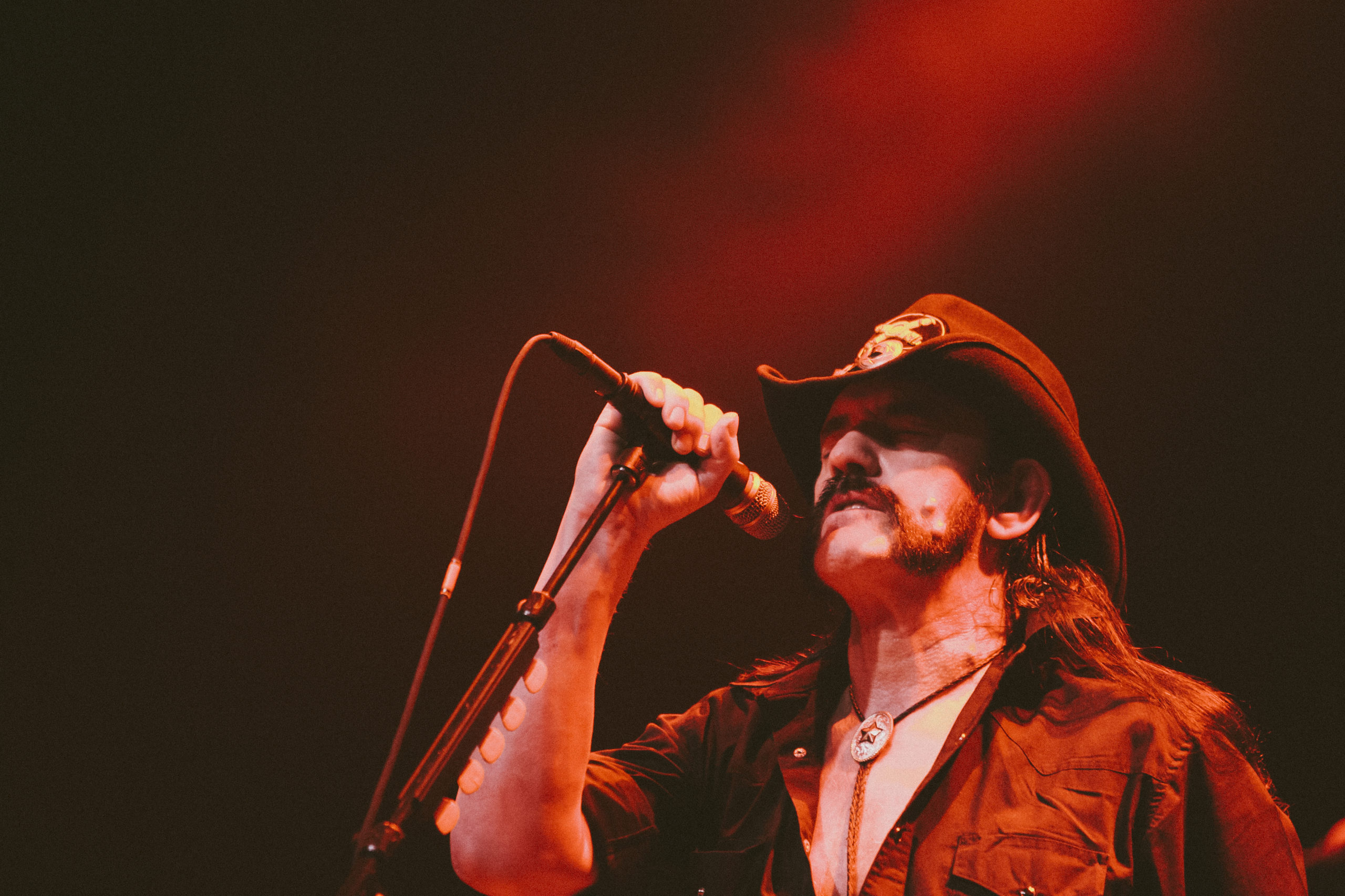 Lemmy from Motorhead performs at Austin Music Hall during SXSW 2010, bathed in red stage light