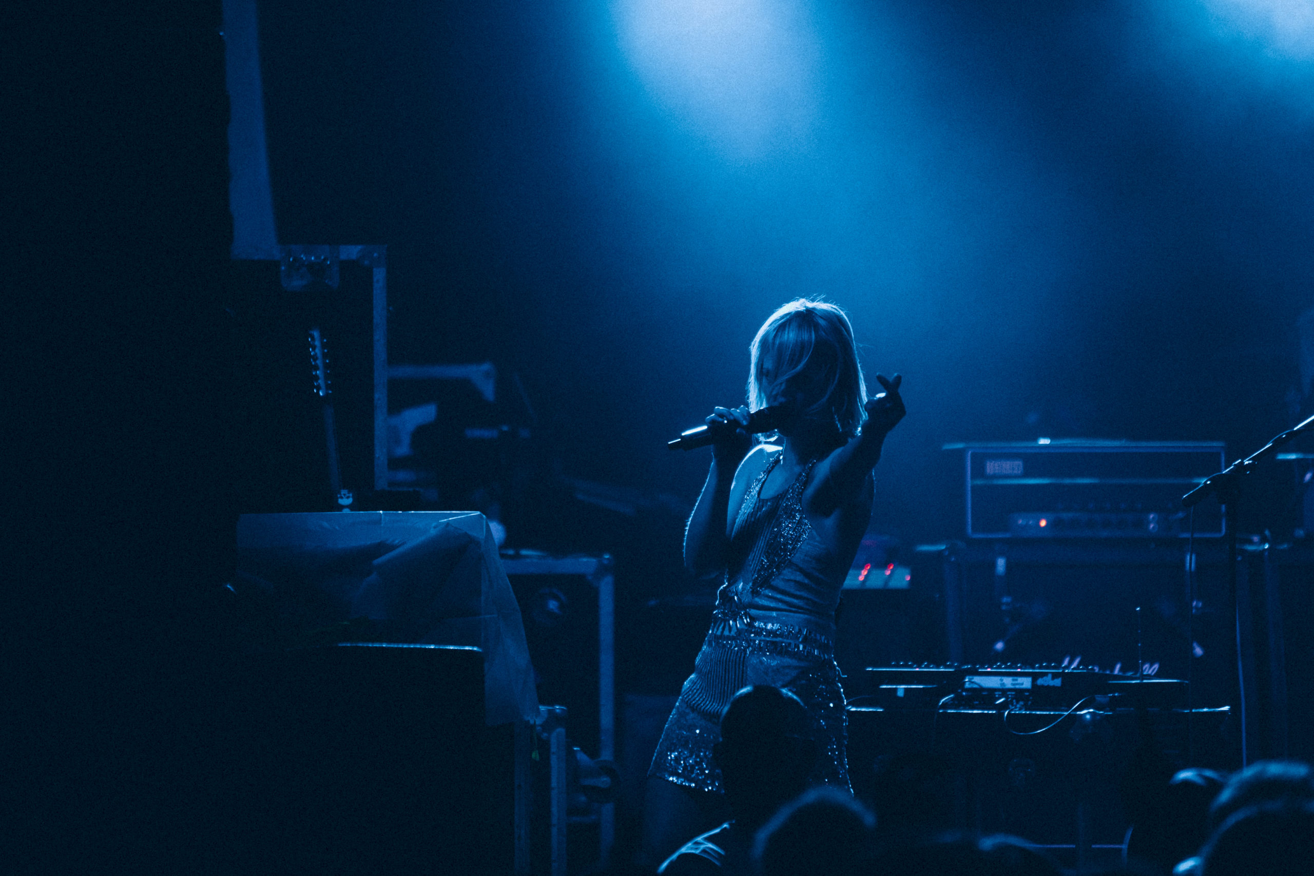 Metric performs at Subb's BBQ during SXSW 2010 with the stage bathed in blue light.